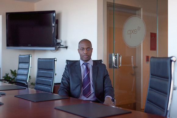 Andrea, from the Congo, sits in his office. 