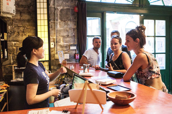 Tomomi Otahara helping customers choose from the extensive sake menu.