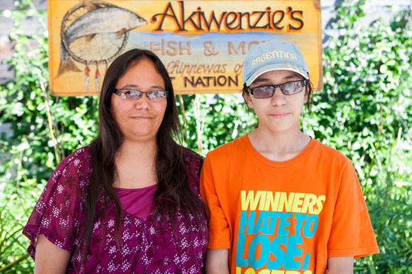 Natasha Akiwenzie and son, M'Kade-Miingan at their booth in the Wychwood Barns Farmer's Market.