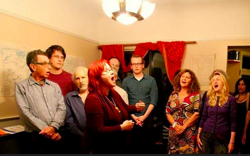 The Element Choir performs a house concert.